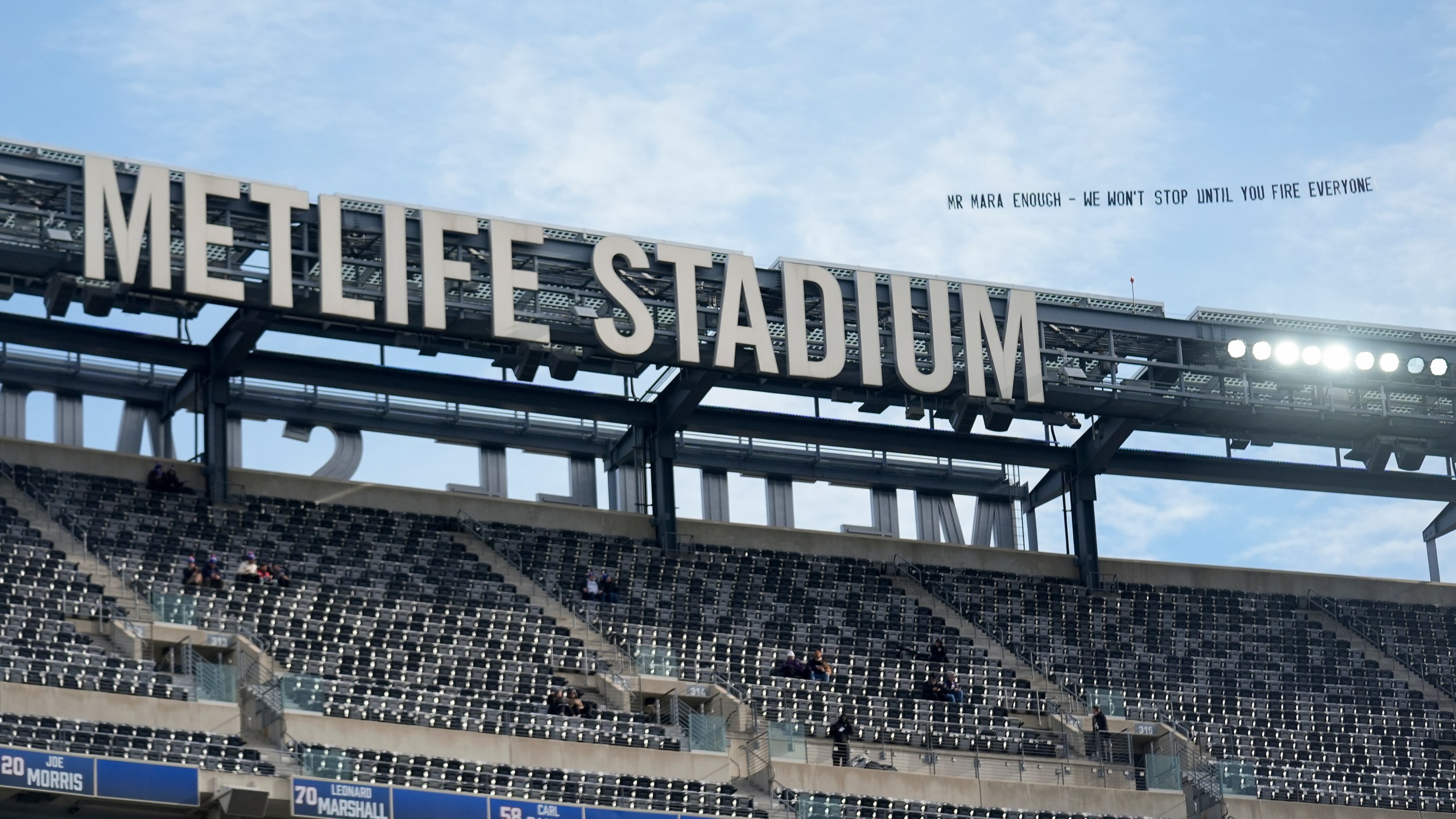 A plan pulls a banner, directed at New York Giants owner John Mara, over Met Life Stadium before an NFL football game between the New York Giants and the Baltimore Ravens, Sunday, Dec. 15, 2024, in East Rutherford, N.J. (AP Photo/Seth Wenig)