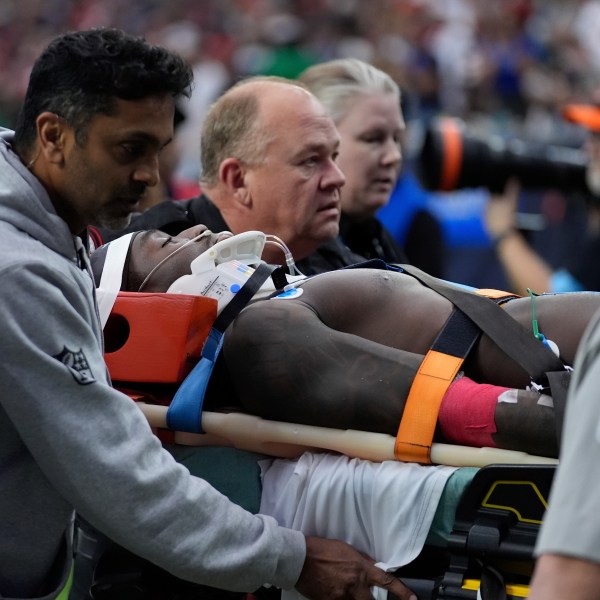 Miami Dolphins wide receiver Grant DuBose (88) is carted off the field after being injured during the second half of an NFL football game against the Houston Texans, Sunday, Dec. 15, 2024, in Houston. (AP Photo/Ashley Landis)