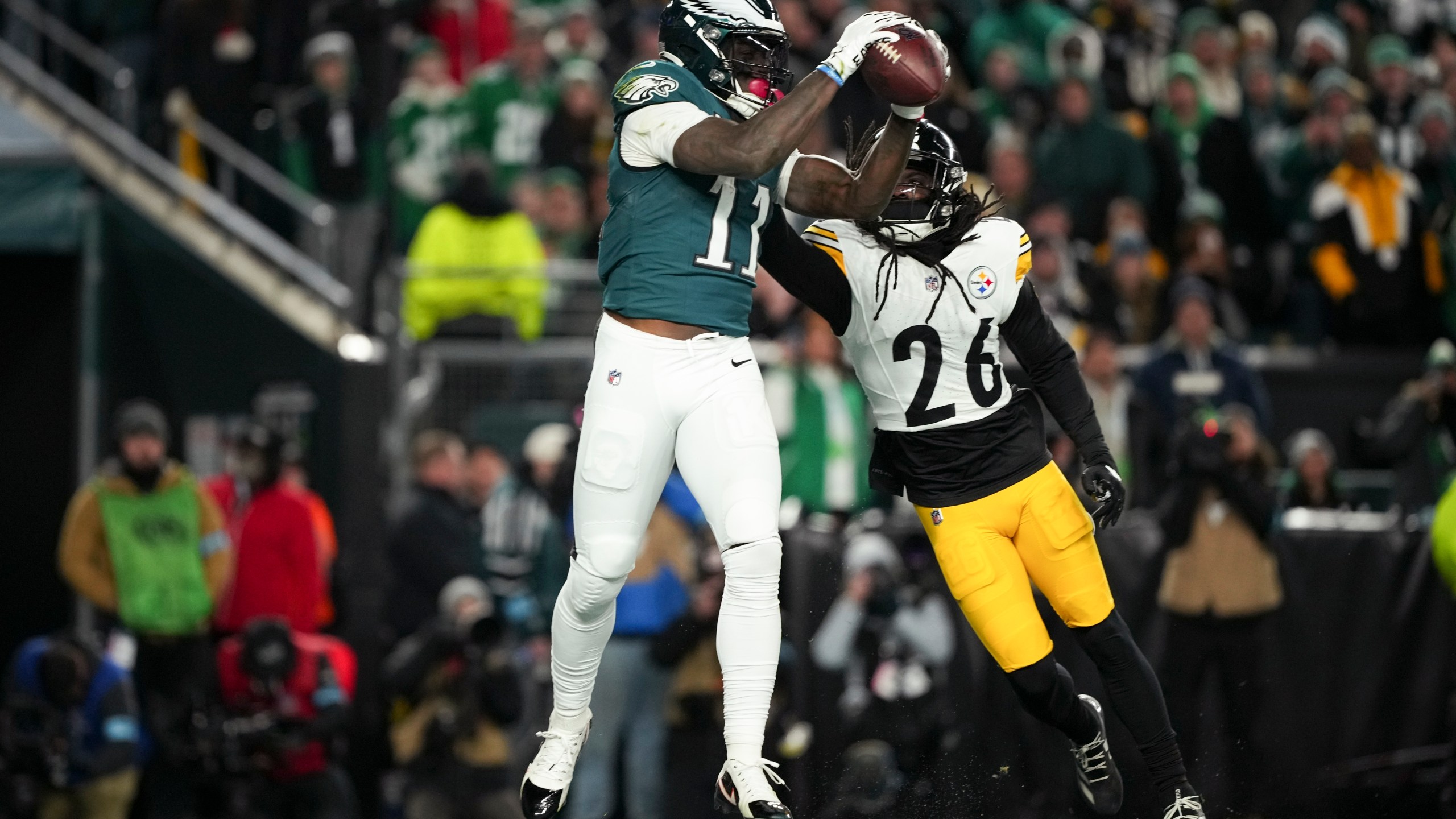 Philadelphia Eagles wide receiver A.J. Brown (11) pulls in the ball for a touchdown in front of Pittsburgh Steelers cornerback Donte Jackson (26) during the first half of an NFL football game Sunday, Dec. 15, 2024, in Philadelphia. (AP Photo/Matt Slocum)