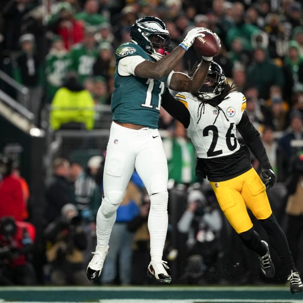 Philadelphia Eagles wide receiver A.J. Brown (11) pulls in the ball for a touchdown in front of Pittsburgh Steelers cornerback Donte Jackson (26) during the first half of an NFL football game Sunday, Dec. 15, 2024, in Philadelphia. (AP Photo/Matt Slocum)