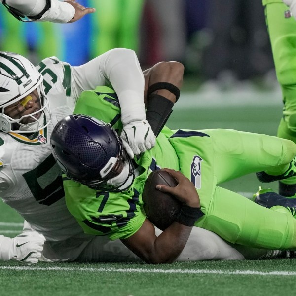 Green Bay Packers' Rashan Gary sacks Seattle Seahawks' Geno Smith during the first half of an NFL football game Sunday, Dec. 15, 2024, in Seattle. (AP Photo/Stephen Brashear)