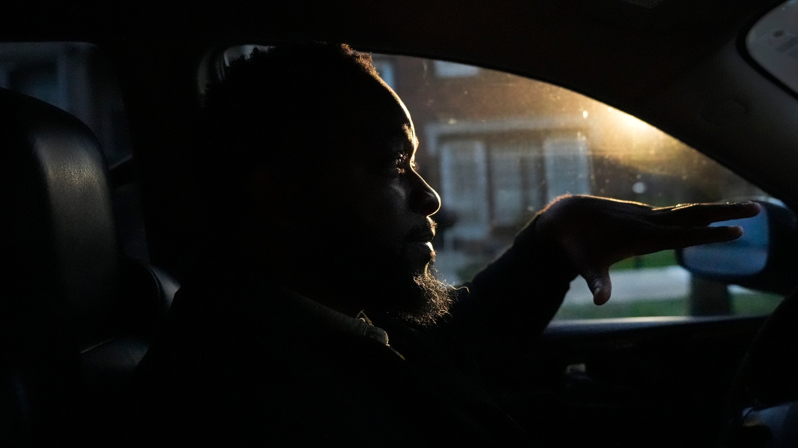 PiggyBack Network, co-founder and CEO Ismael El-Amin talks about the Piggyback ride-share program on Friday, Oct. 18, 2024, while he waits to drop off the last of two children he drove to school as part of the program in Chicago. (AP Photo/Charles Rex Arbogast)