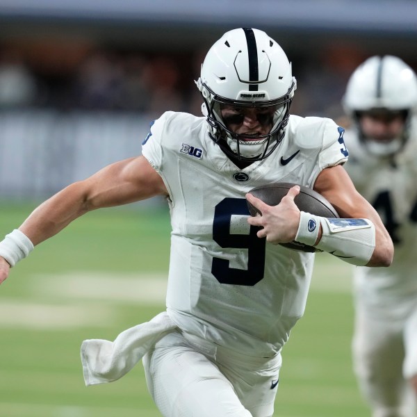 Penn State quarterback Beau Pribula (9) runs up field during the second half of the Big Ten championship NCAA college football game against Oregon, Saturday, Dec. 7, 2024, in Indianapolis. (AP Photo/Darron Cummings)