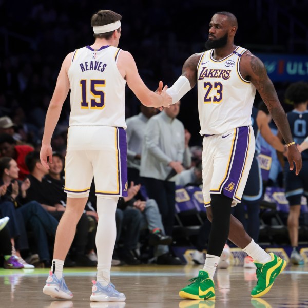 Los Angeles Lakers forward LeBron James (23) celebrates with guard Austin Reaves (15) during the first half of an NBA basketball game against the Memphis Grizzlies, Sunday, Dec. 15, 2024, in Los Angeles. (AP Photo/Jessie Alcheh)