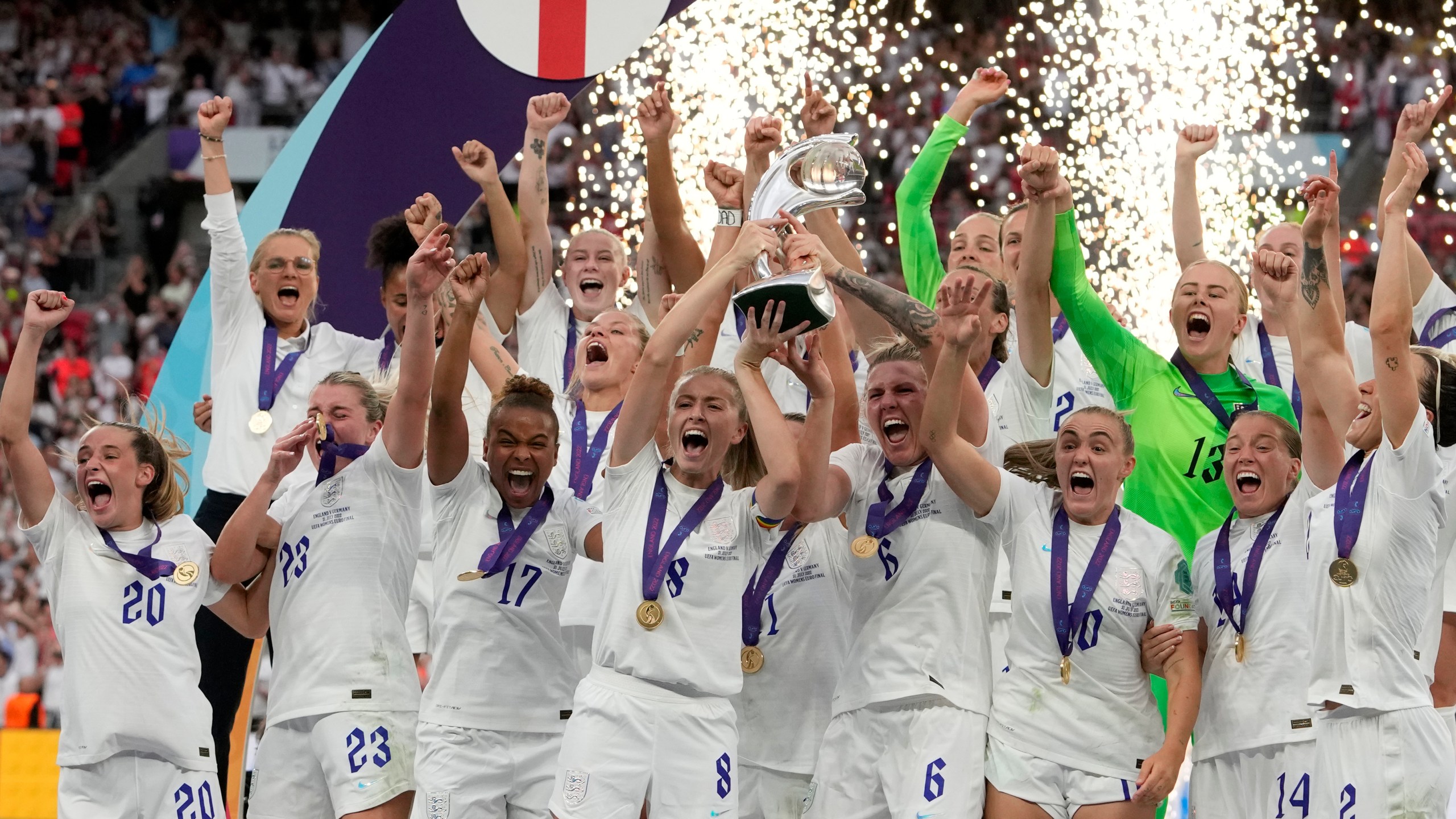 FILE - England's Leah Williamson, center left, and Millie Bright lift the trophy after winning the Women's Euro 2022 final soccer match between England and Germany at Wembley stadium in London, Sunday, July 31, 2022. England won 2-1. (AP Photo/Alessandra Tarantino, File)