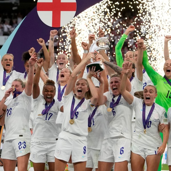 FILE - England's Leah Williamson, center left, and Millie Bright lift the trophy after winning the Women's Euro 2022 final soccer match between England and Germany at Wembley stadium in London, Sunday, July 31, 2022. England won 2-1. (AP Photo/Alessandra Tarantino, File)