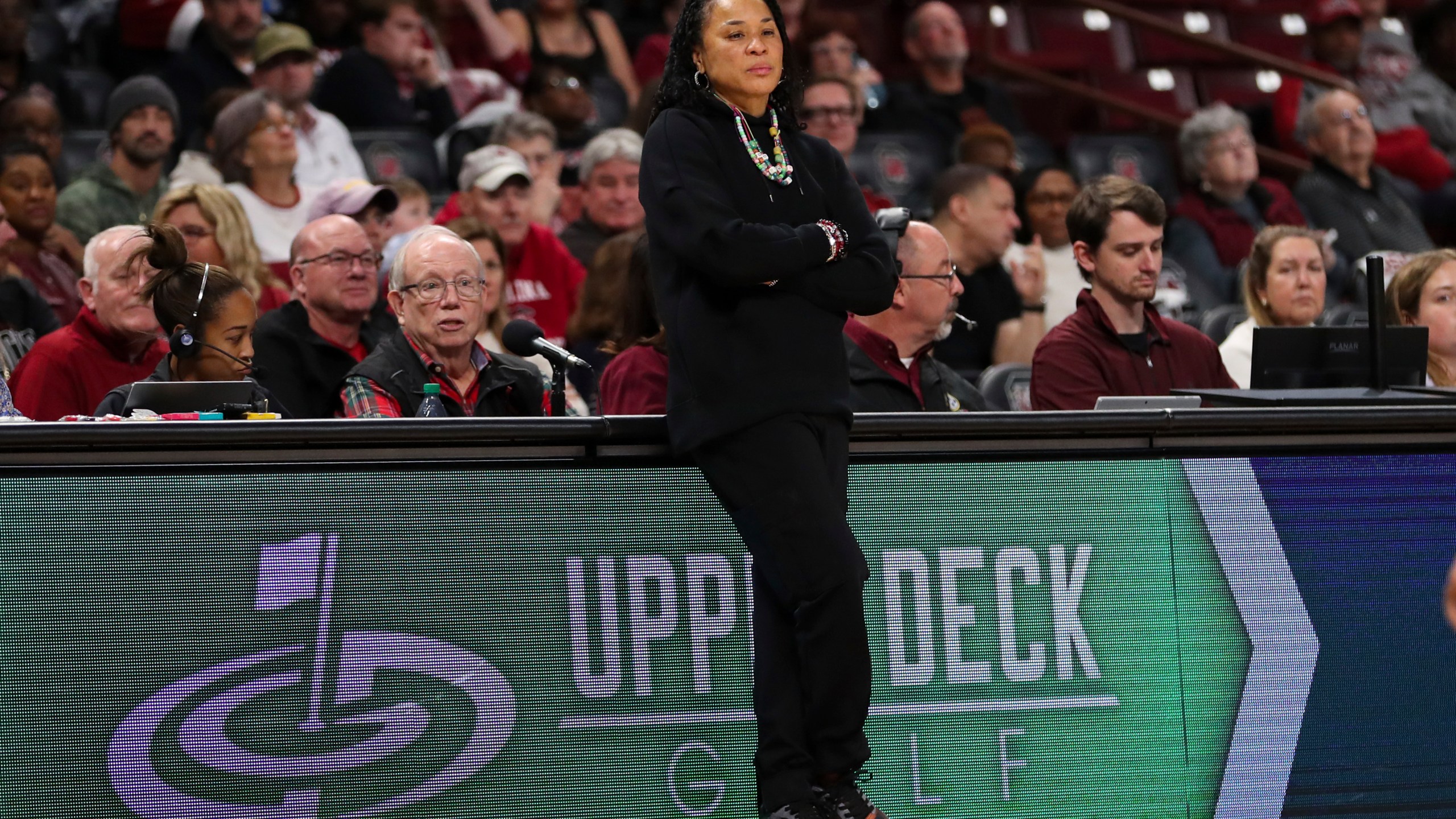 South Carolina head coach Dawn Staley, center, leans on the scorers table during the second half of an NCAA college basketball game against South Florida, Sunday, Dec. 15, 2024, in Columbia, S.C. (AP Photo/Artie Walker Jr.)