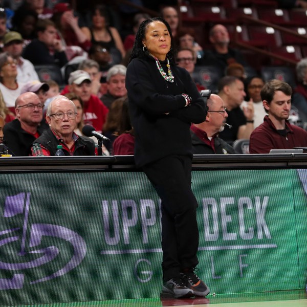 South Carolina head coach Dawn Staley, center, leans on the scorers table during the second half of an NCAA college basketball game against South Florida, Sunday, Dec. 15, 2024, in Columbia, S.C. (AP Photo/Artie Walker Jr.)