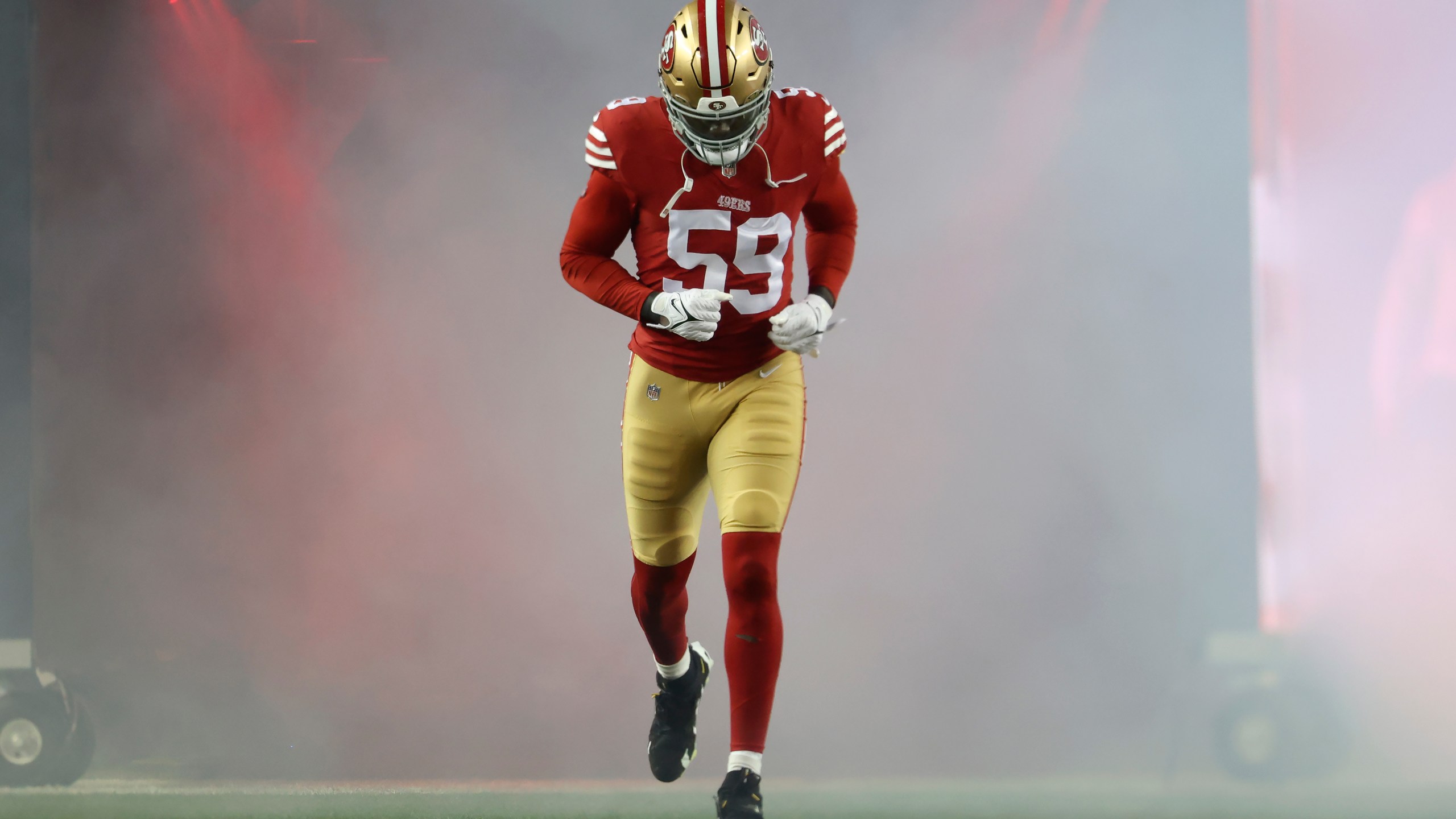 San Francisco 49ers linebacker De'Vondre Campbell jogs onto the field before an NFL football game against the Los Angeles Rams in Santa Clara, Calif., Thursday, Dec. 12, 2024. (AP Photo/Jed Jacobsohn)