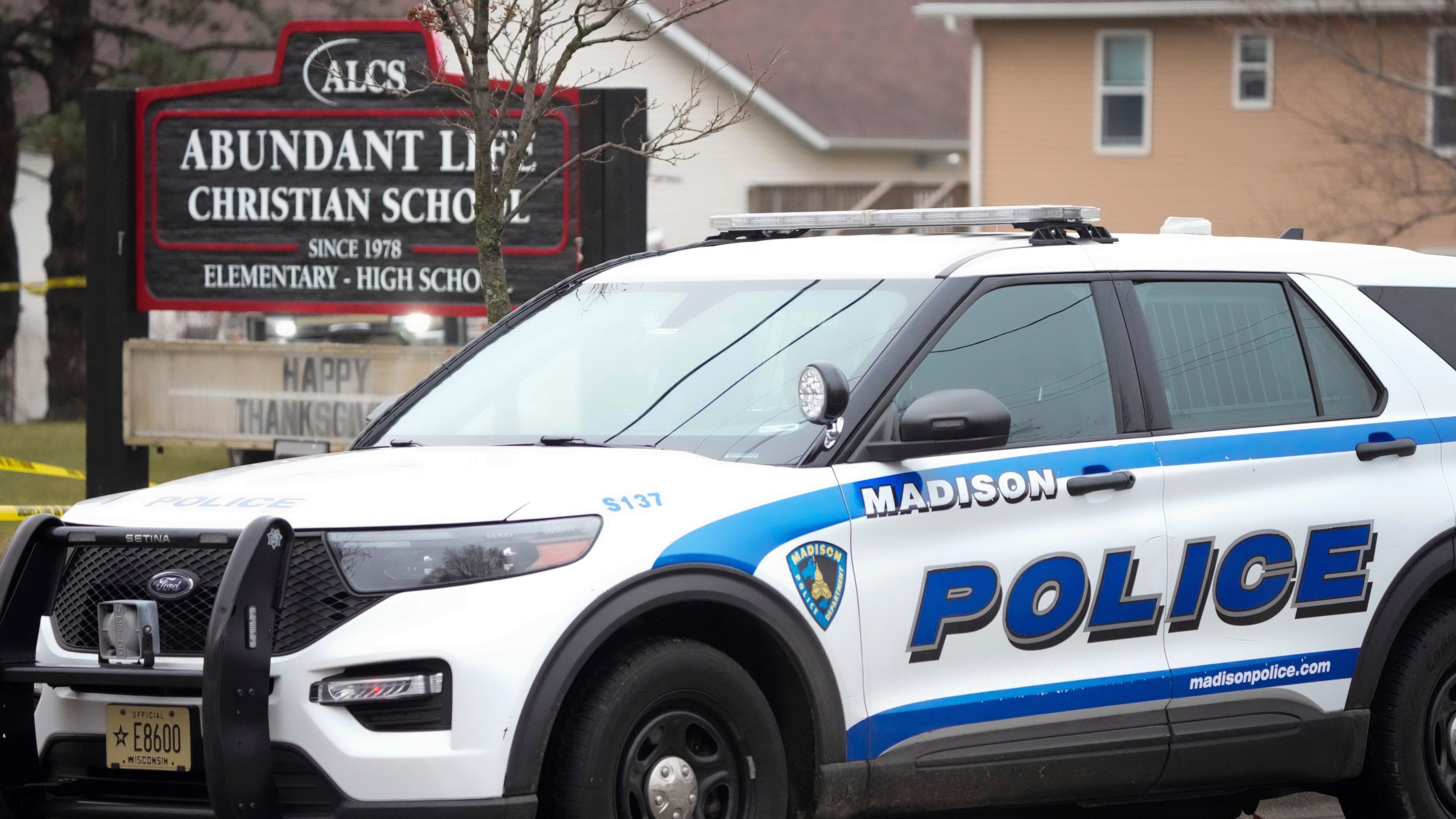 Emergency vehicles are parked outside the Abundant Life Christian School in Madison, Wis., where multiple injuries were reported following a shooting, Monday, Dec. 16, 2024. (AP Photo/Morry Gash)