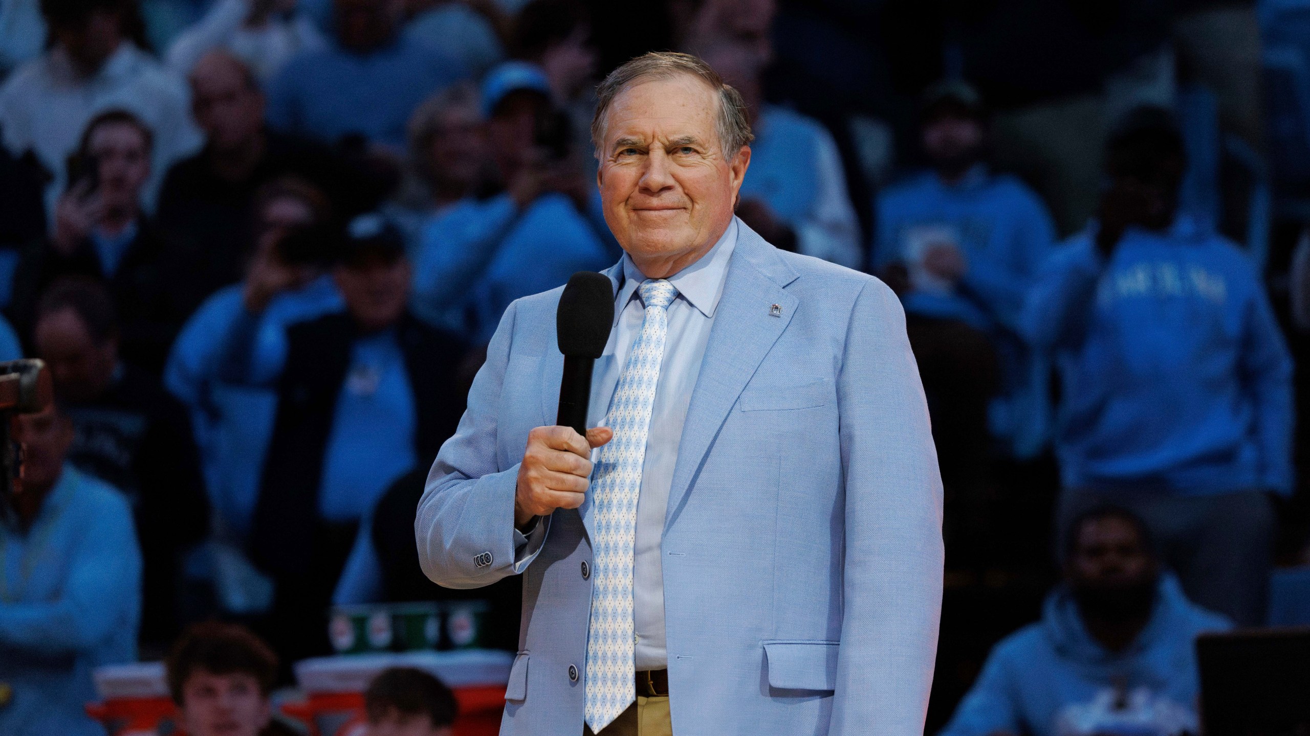 New North Carolina head football coach Bill Belichick speaks to the crowd at Dean Smith Center during halftime of an NCAA college basketball game between La Salle and North Carolina in Chapel Hill, N.C., Saturday, Dec. 14, 2024. (AP Photo/Ben McKeown)