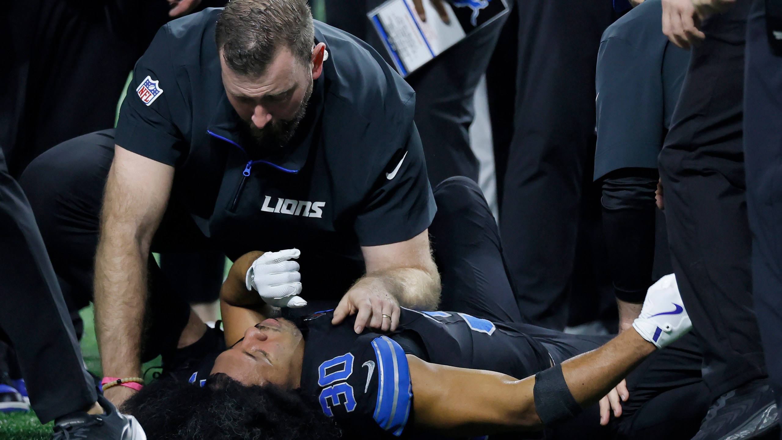 Trainers check on Detroit Lions cornerback Khalil Dorsey (30) during the first half of an NFL football game against the Buffalo Bills, Sunday, Dec. 15, 2024, in Detroit. (AP Photo/Duane Burleson)