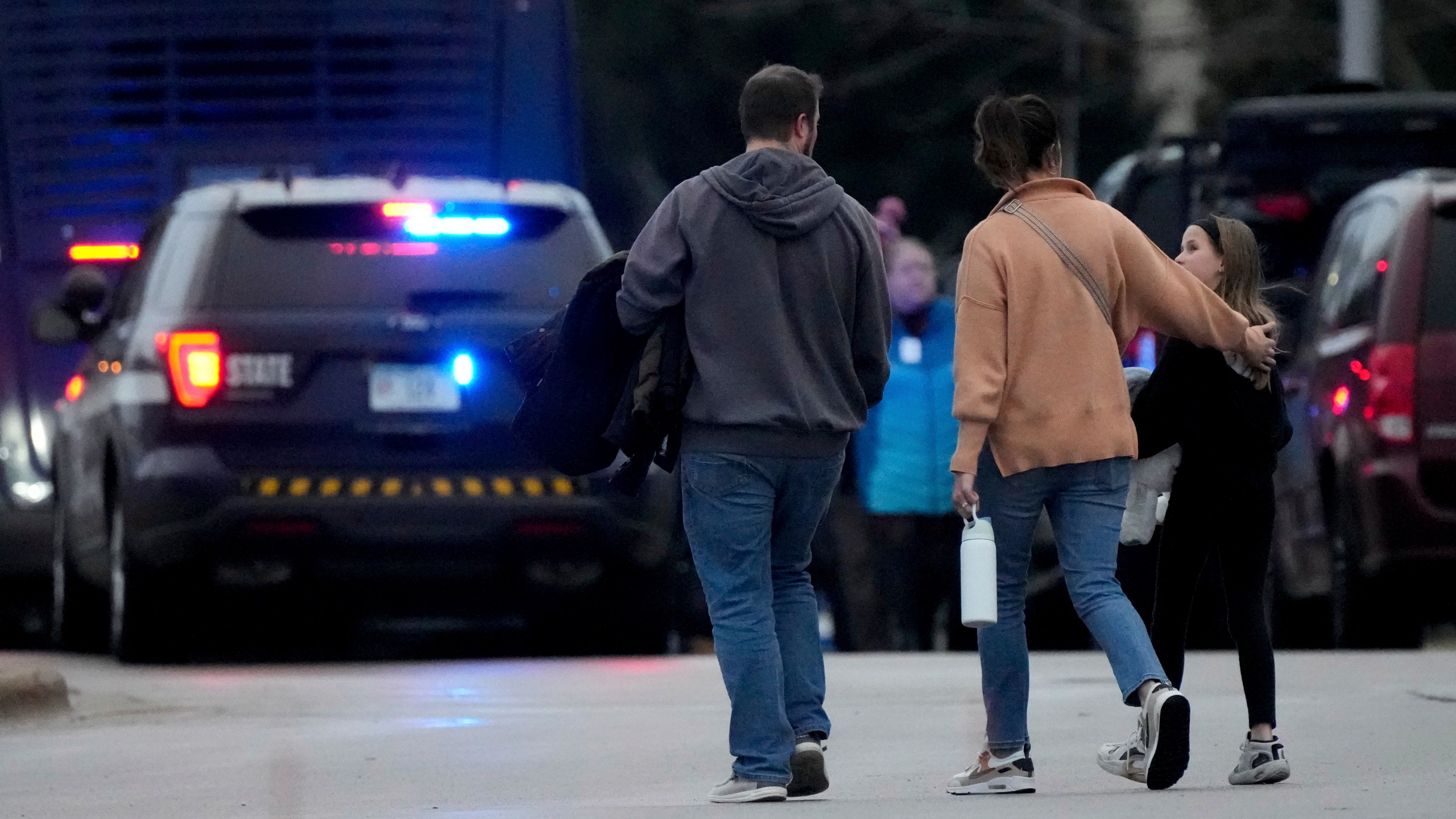 Families leave the SSMI Health Center, set up as a reunification center, following a shooting, Monday, Dec. 16, 2024 in Madison, Wis. (AP Photo/Morry Gash)