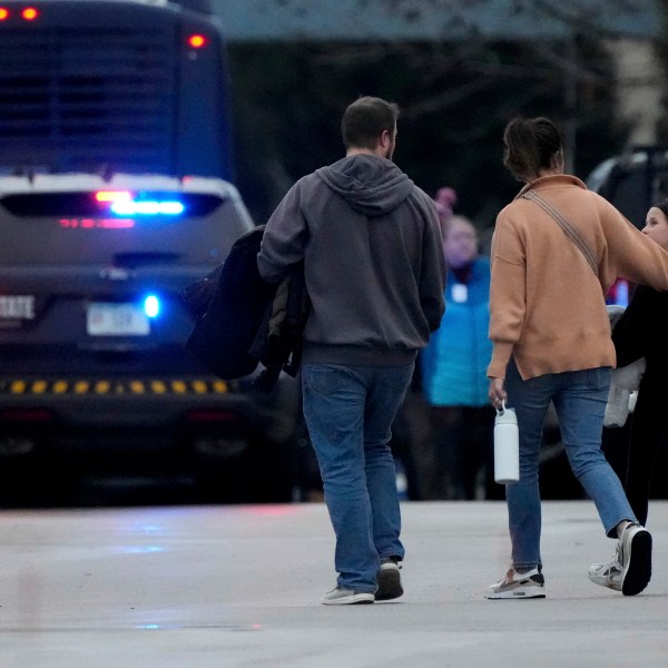 Families leave the SSMI Health Center, set up as a reunification center, following a shooting, Monday, Dec. 16, 2024 in Madison, Wis. (AP Photo/Morry Gash)