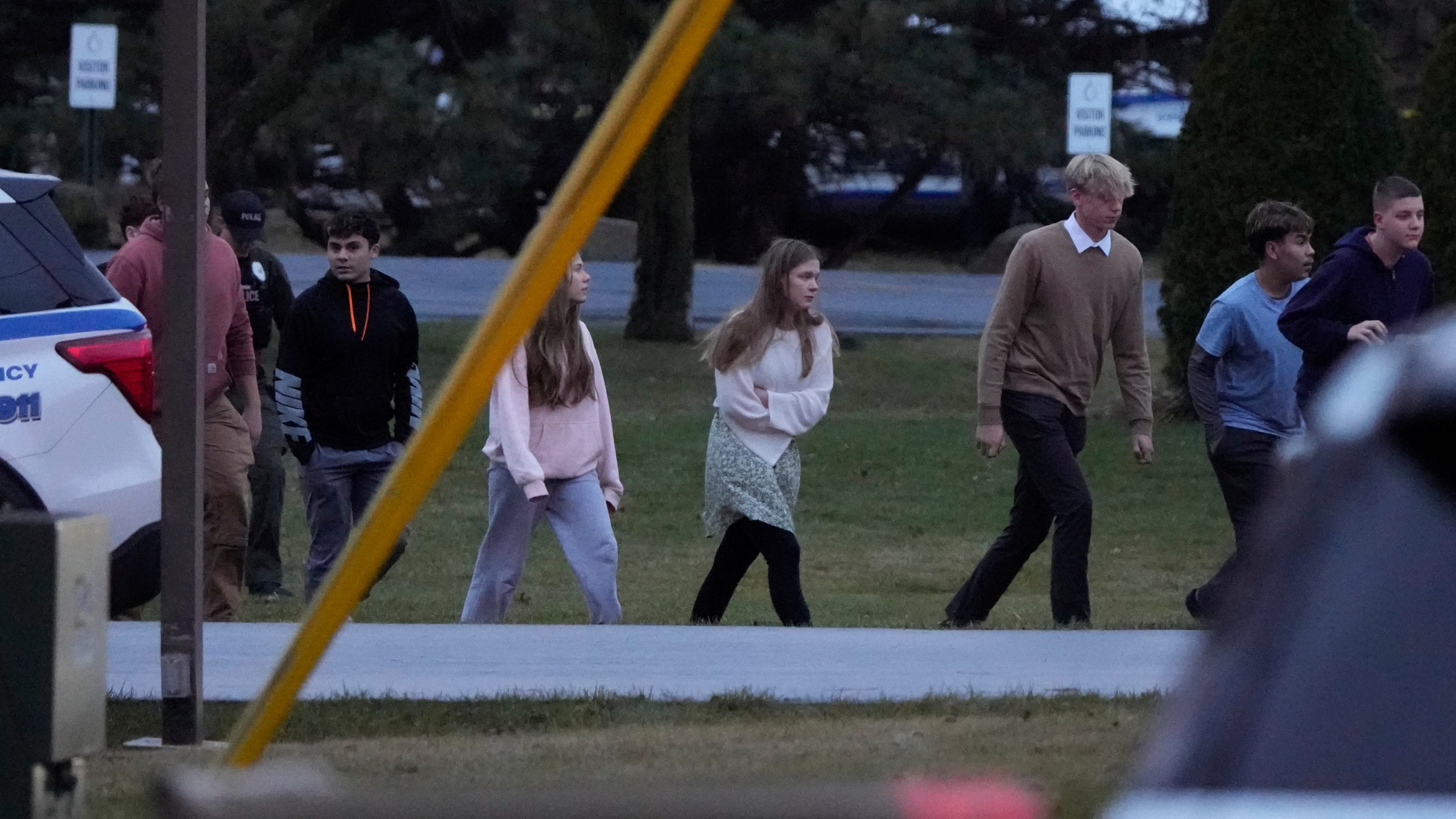 Students walk to a bus as they leave the shelter following a shooting at the Abundant Life Christian School, Monday, Dec. 16, 2024. (AP Photo/Morry Gash)