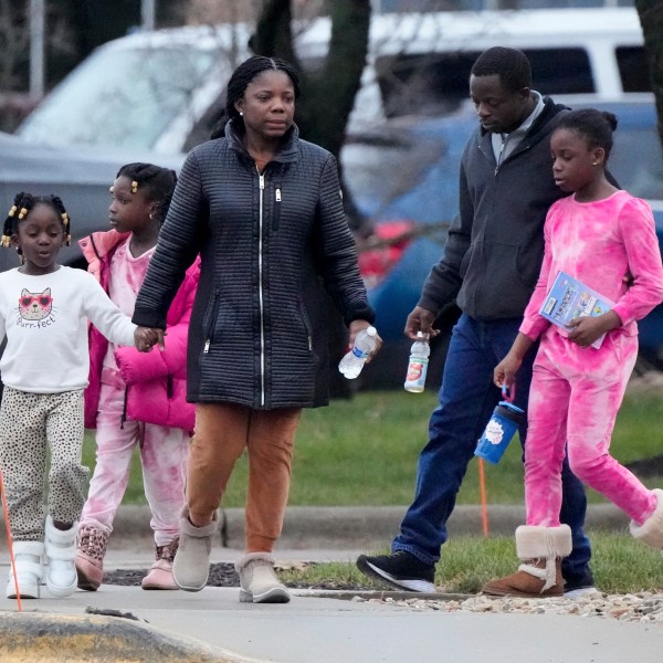 A family leaves the SSMI Health Center, set up as an reunification center, in Madison, Wis., following a shooting, Monday, Dec. 16, 2024. (AP Photo/Morry Gash)