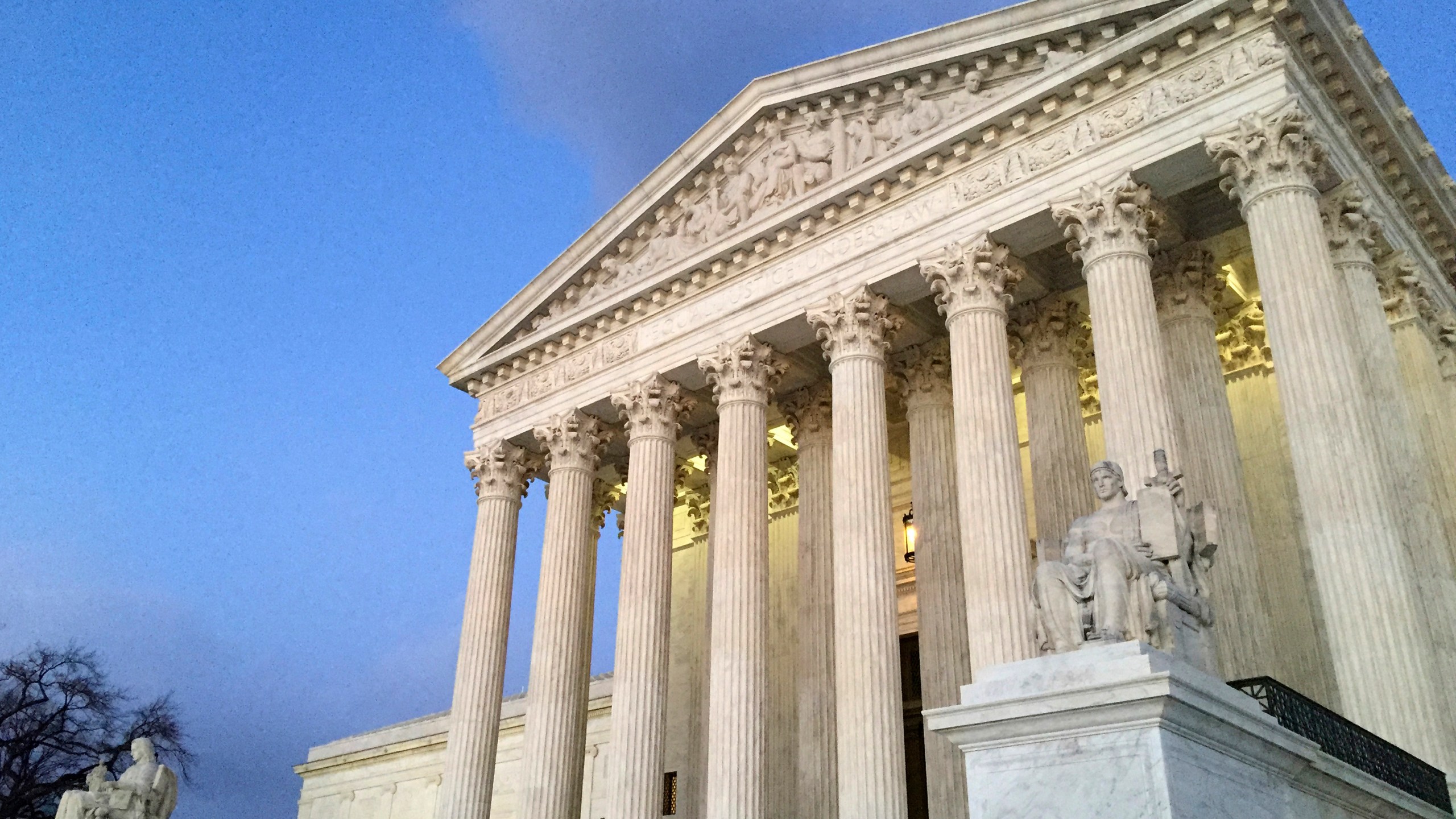 FILE - People stand on the steps of the Supreme Court at sunset in Washington, Feb. 13, 2016. (AP Photo/Jon Elswick, File)