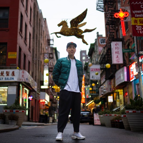 Karho Leung, 33, one of the founders of 12 Pell, a local barbershop, stands for his portrait on Pell Street in Manhattan's Chinatown neighborhood, Thursday, Jan. 25, 2024, in New York. Anchored in the Chinatown community and equally at home elsewhere in the city, Leung says he's "building the world that I want to live in… not asking for permission." (AP Photo/John Minchillo)