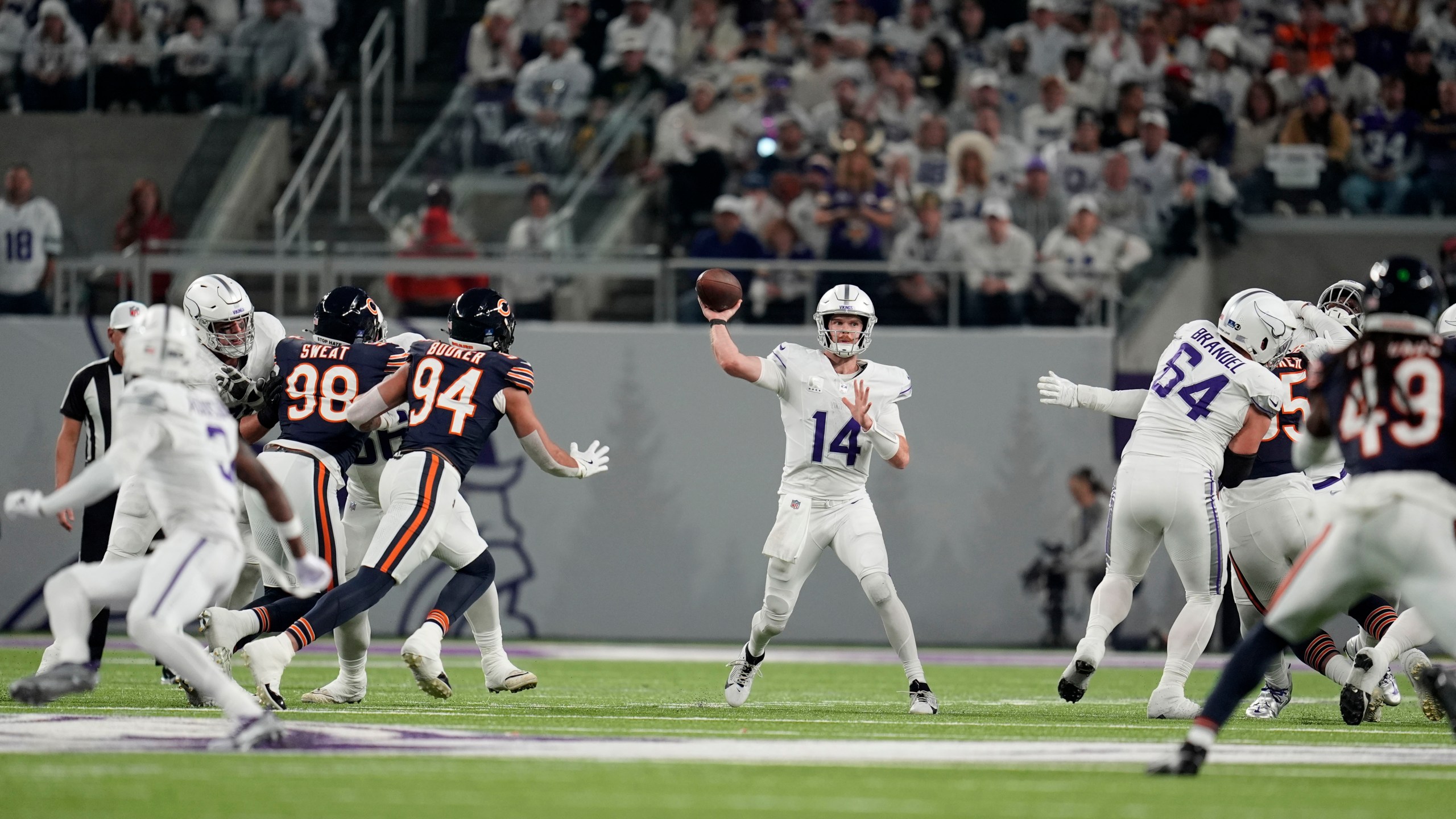 Minnesota Vikings quarterback Sam Darnold (14) throws a pass during the first half of an NFL football game against the Chicago Bears, Monday, Dec. 16, 2024, in Minneapolis. (AP Photo/Abbie Parr)