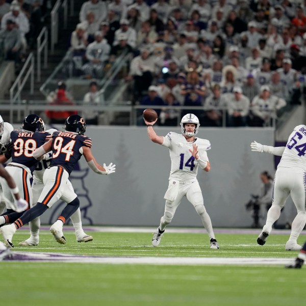 Minnesota Vikings quarterback Sam Darnold (14) throws a pass during the first half of an NFL football game against the Chicago Bears, Monday, Dec. 16, 2024, in Minneapolis. (AP Photo/Abbie Parr)