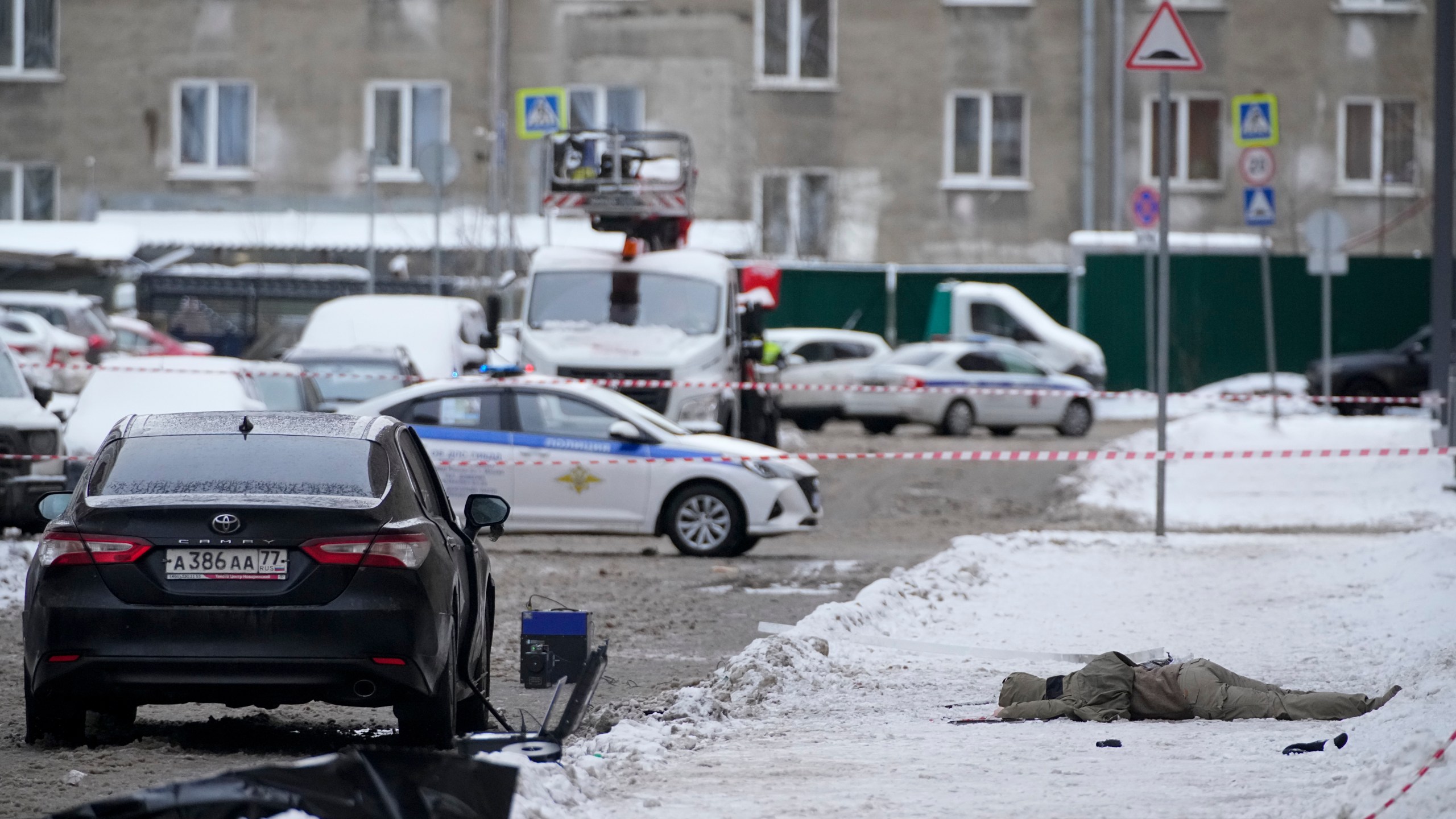 A body lies at the place where Lt. General Igor Kirillov, the head of Russia's Nuclear, Biological, and Chemical Defence Forces was killed by an explosive device planted close to a residential apartment's block in Moscow, Russia, Tuesday, Dec. 17, 2024. (AP Photo)