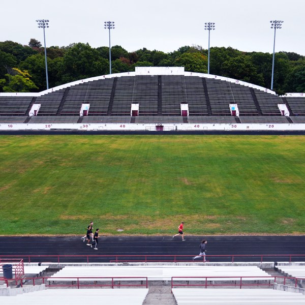 Students from a Boston Latin School physical education class run on the track at White Stadium, Thursday, Sept. 26, 2024, at Franklin Park in Boston. A plan to renovate the aging stadium in Boston for a professional women's soccer team has sparked controversy over concerns it will displace some youth sports and limit access to a public park in one of the city's most diverse neighborhoods. (AP Photo/Charles Krupa)