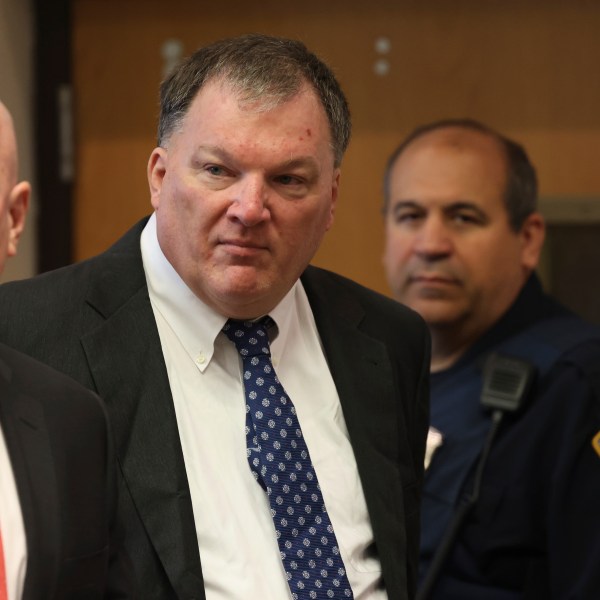 FILE - Rex Heuermann, center, charged in the Gilgo Beach serial killings on Long Island, appears for a hearing, Tuesday, July 30, 2024, at Suffolk County Court in Riverhead, N.Y. (James Carbone/Newsday via AP, File, Pool)