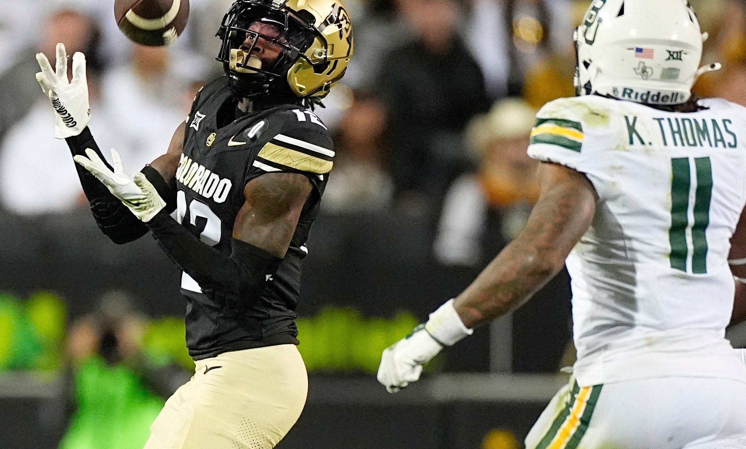 FILE - Colorado wide receiver Travis Hunter, left, pulls in a pass ahead of Baylor linebacker Keaton Thomas during the second half of an NCAA college football game Saturday, Sept. 21, 2024, in Boulder, Colo. (AP Photo/David Zalubowski, File)