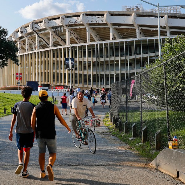 FILE - In this Aug. 5, 2017, file photo people make their way to RFK Stadium in Washington before an MLS soccer match between D.C. United and Toronto FC. (AP Photo/Pablo Martinez Monsivais, File)