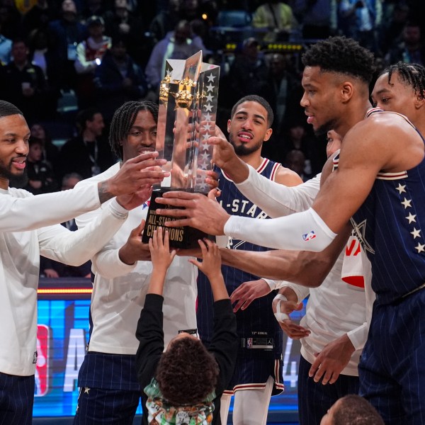 FILE - The East team, lead by captain Milwaukee Bucks forward Giannis Antetokounmpo, right, hoists the trophy after defeating the West 211-186 in the NBA All-Star basketball game in Indianapolis, Sunday, Feb. 18, 2024. (AP Photo/Darron Cummings, File)