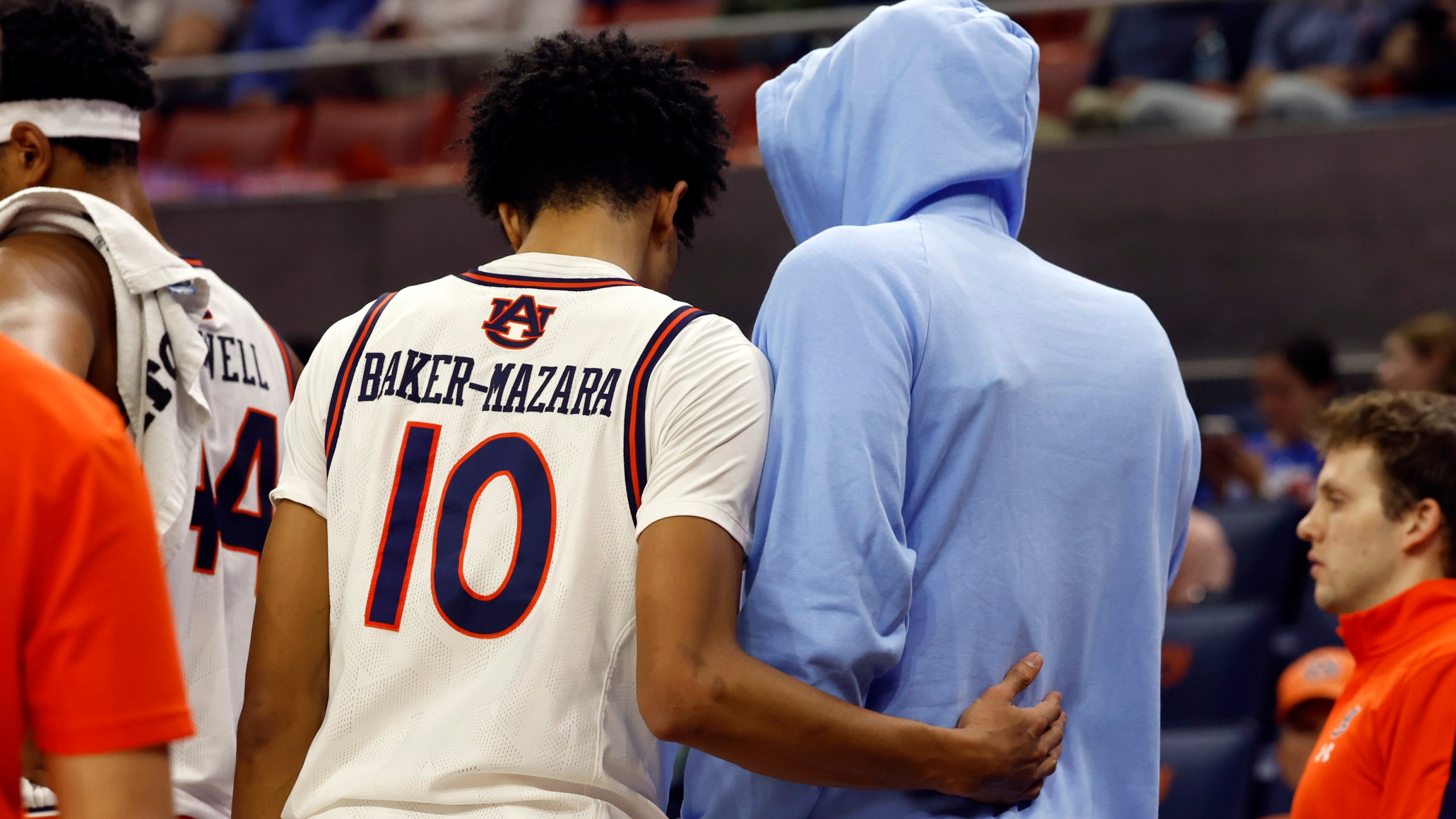 Auburn guard Chad Baker-Mazara (10) consoles teammate forward Johni Broome after he sustained an injury against Georgia State during the first half of an NCAA college basketball game, Tuesday, Dec. 17, 2024, in Auburn, Ala. (AP Photo/ Butch Dill)