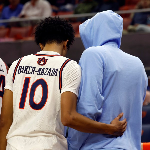 Auburn guard Chad Baker-Mazara (10) consoles teammate forward Johni Broome after he sustained an injury against Georgia State during the first half of an NCAA college basketball game, Tuesday, Dec. 17, 2024, in Auburn, Ala. (AP Photo/ Butch Dill)