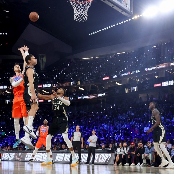 Oklahoma City Thunder center Isaiah Hartenstein (55) shoots against Milwaukee Bucks center Brook Lopez (11) and forward Giannis Antetokounmpo (34) during the first half of the championship game in the NBA Cup basketball tournament Tuesday, Dec. 17, 2024, in Las Vegas. (AP Photo/Ian Maule)