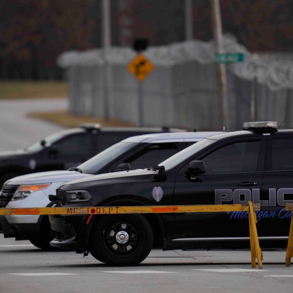 Police cars are parked outside of Indiana State Prison on Tuesday, Dec. 17, 2024, in Michigan City, Ind., where, barring last-minute court action or intervention by Gov. Eric Holcomb, Joseph Corcoran, 49, convicted in the 1997 killings of his brother and three other people, is scheduled to be put to death by lethal injection before sunrise Wednesday, Dec. 18. (AP Photo/Erin Hooley)