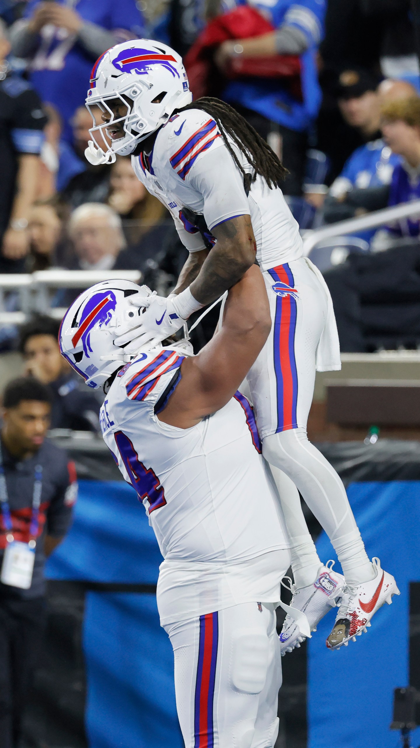 Buffalo Bills running back James Cook, top, is congratulated by guard O'Cyrus Torrence after scoring against the Detroit Lions during the second half of an NFL football game, Sunday, Dec. 15, 2024, in Detroit. (AP Photo/Duane Burleson)