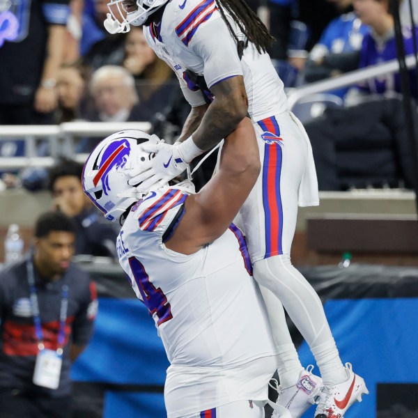 Buffalo Bills running back James Cook, top, is congratulated by guard O'Cyrus Torrence after scoring against the Detroit Lions during the second half of an NFL football game, Sunday, Dec. 15, 2024, in Detroit. (AP Photo/Duane Burleson)