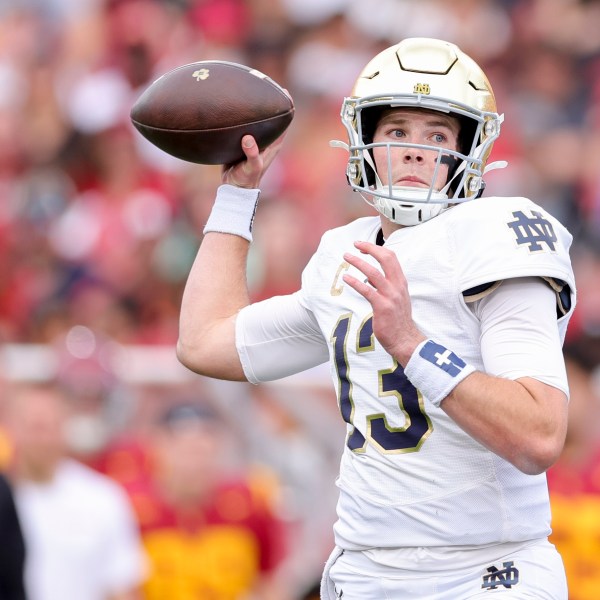 Notre Dame quarterback Riley Leonard throws during the first half of an NCAA college football game against Southern California, Saturday, Nov. 30, 2024, in Los Angeles. (AP Photo/Ryan Sun)