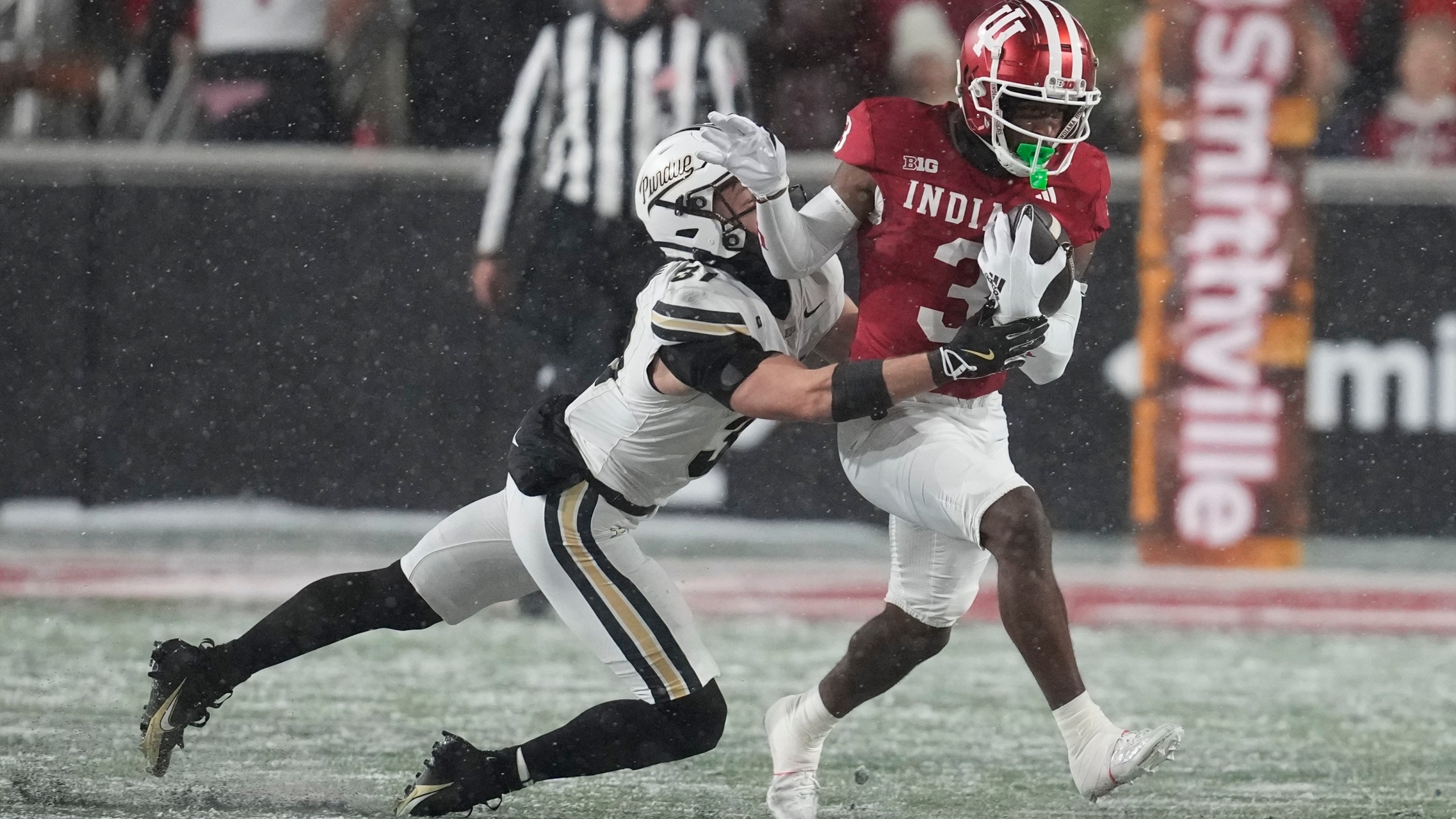 FILE - Indiana wide receiver Omar Cooper Jr. (3) is tackled by Purdue defensive back Dillon Thieneman (31) during the first half of an NCAA college football game, Saturday, Nov. 30, 2024, in Bloomington, Ind. (AP Photo/Darron Cummings, File)