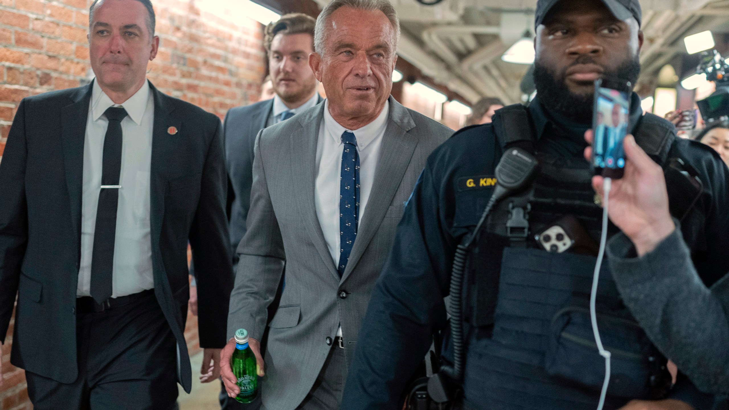 Robert F. Kennedy Jr., President-elect Donald Trump's nominee to be Secretary of Health and Human Services, center, walks to meet with Sen. John Thune, R-S.D. at the Capitol in Washington, Tuesday, Dec. 17, 2024. (AP Photo/Jose Luis Magana)