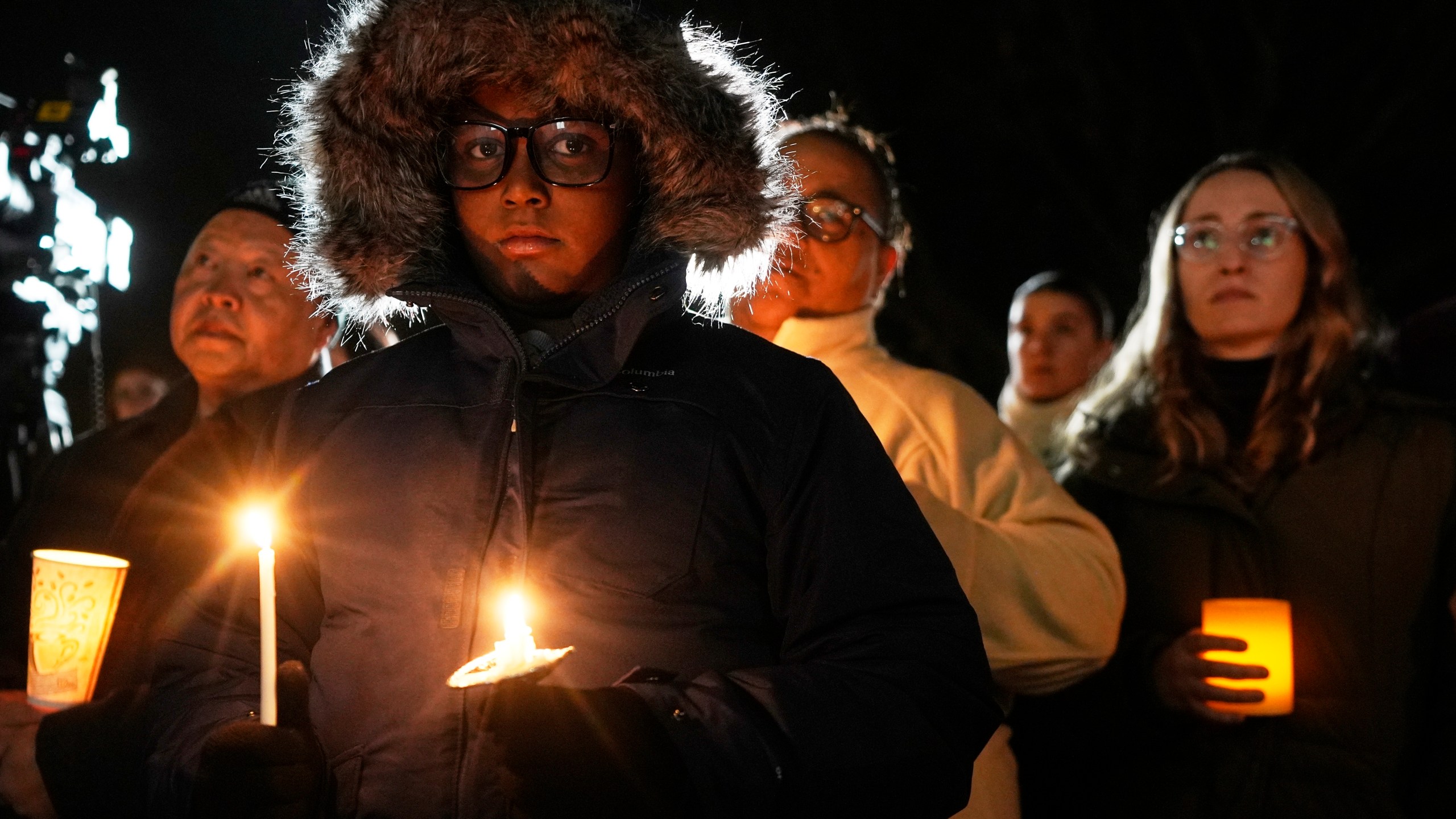 Supporters hold candles during a candlelight vigil Tuesday, Dec. 17, 2024, outside the Wisconsin Capitol in Madison, Wis., following a shooting at the Abundant Life Christian School on Monday, Dec. 16. (AP Photo/Morry Gash)