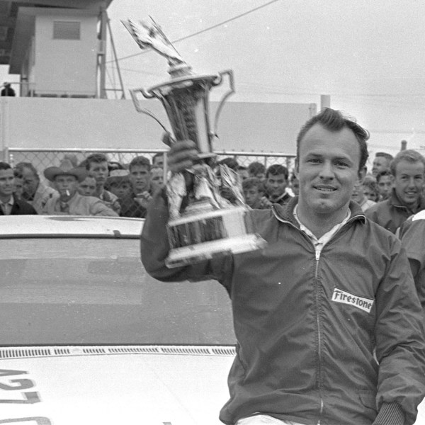 FILE - In this Feb. 14, 1965, file photo, Fred Lorenzen, of Elmhurst, Ill., gives a victory wave after winning the Daytona 500 mile stock car auto race which was halted by rain at the end of 133 laps, in Daytona Beach, Fla. (AP Photo/File)