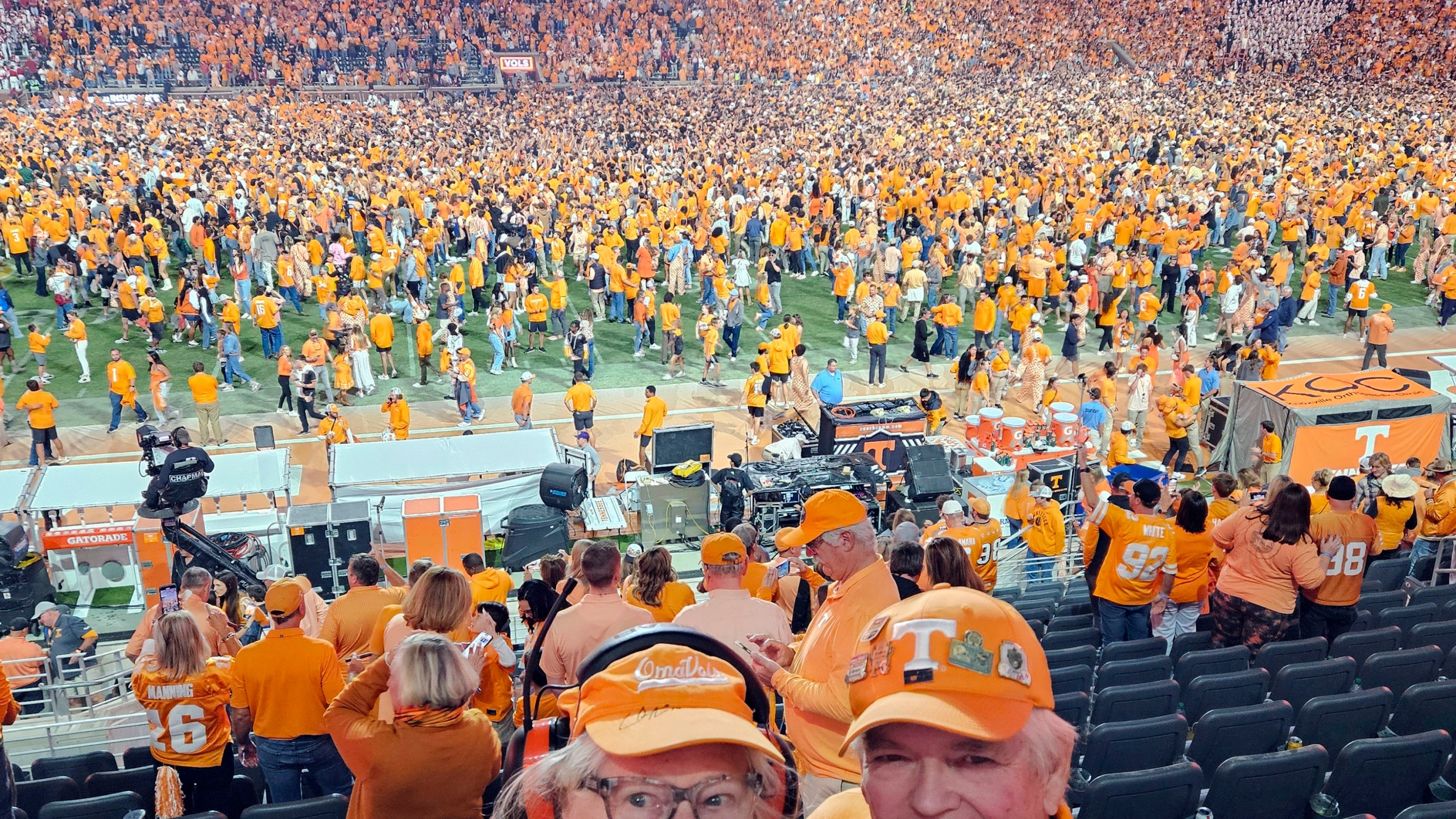 In this image provided by Earl Brown, Brown and his wife Judy pose as Tennessee fans storm the field after the Volunteers defeated Alabama in an NCAA college football game, Saturday, Oct. 19, 2024, in Knoxville, Tenn. (Earl Brown via AP)