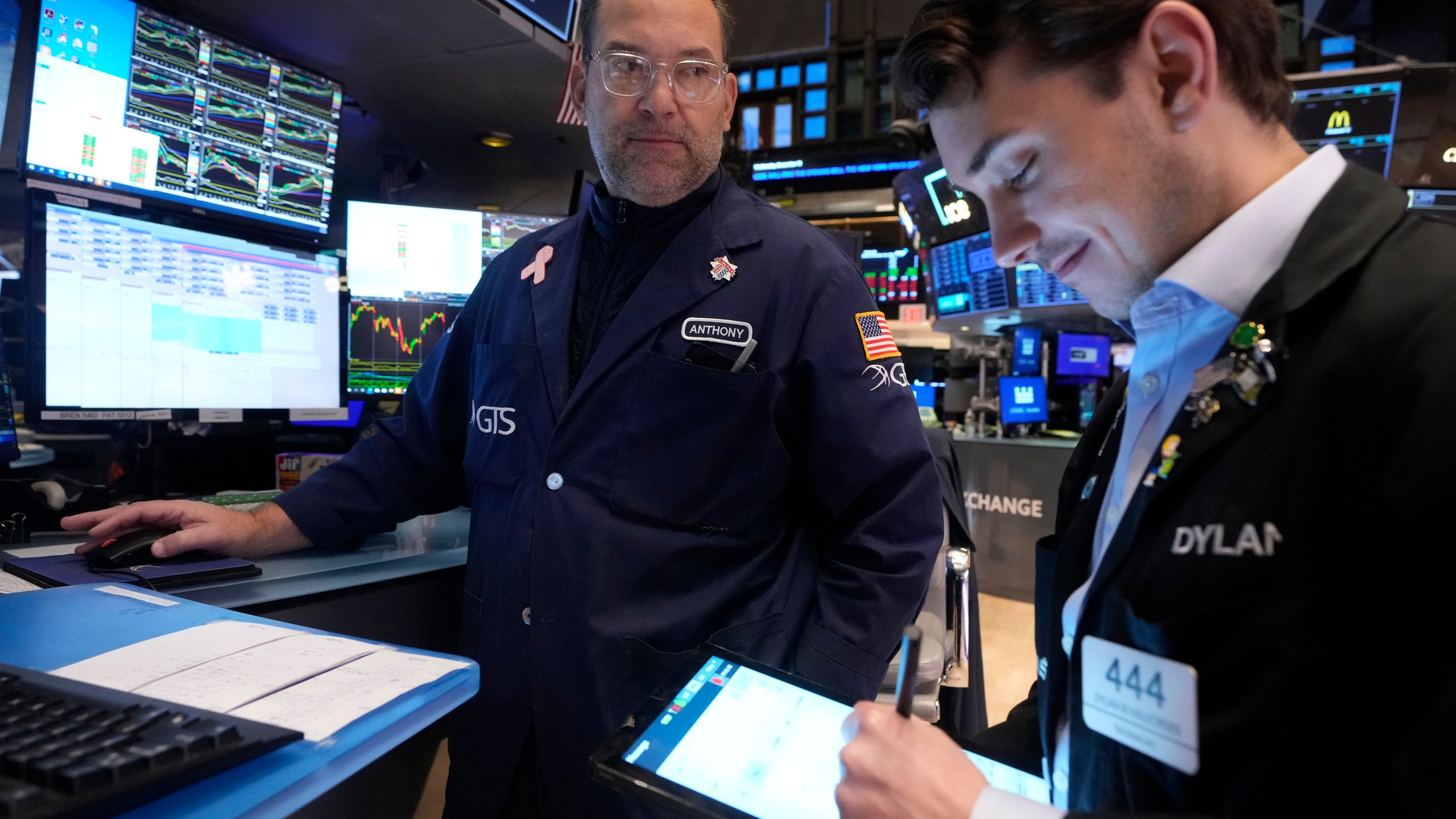 Specialist Anthony Matesic, left, works at his post on the floor of the New York Stock Exchange, Wednesday, Dec. 18, 2024. (AP Photo/Richard Drew)