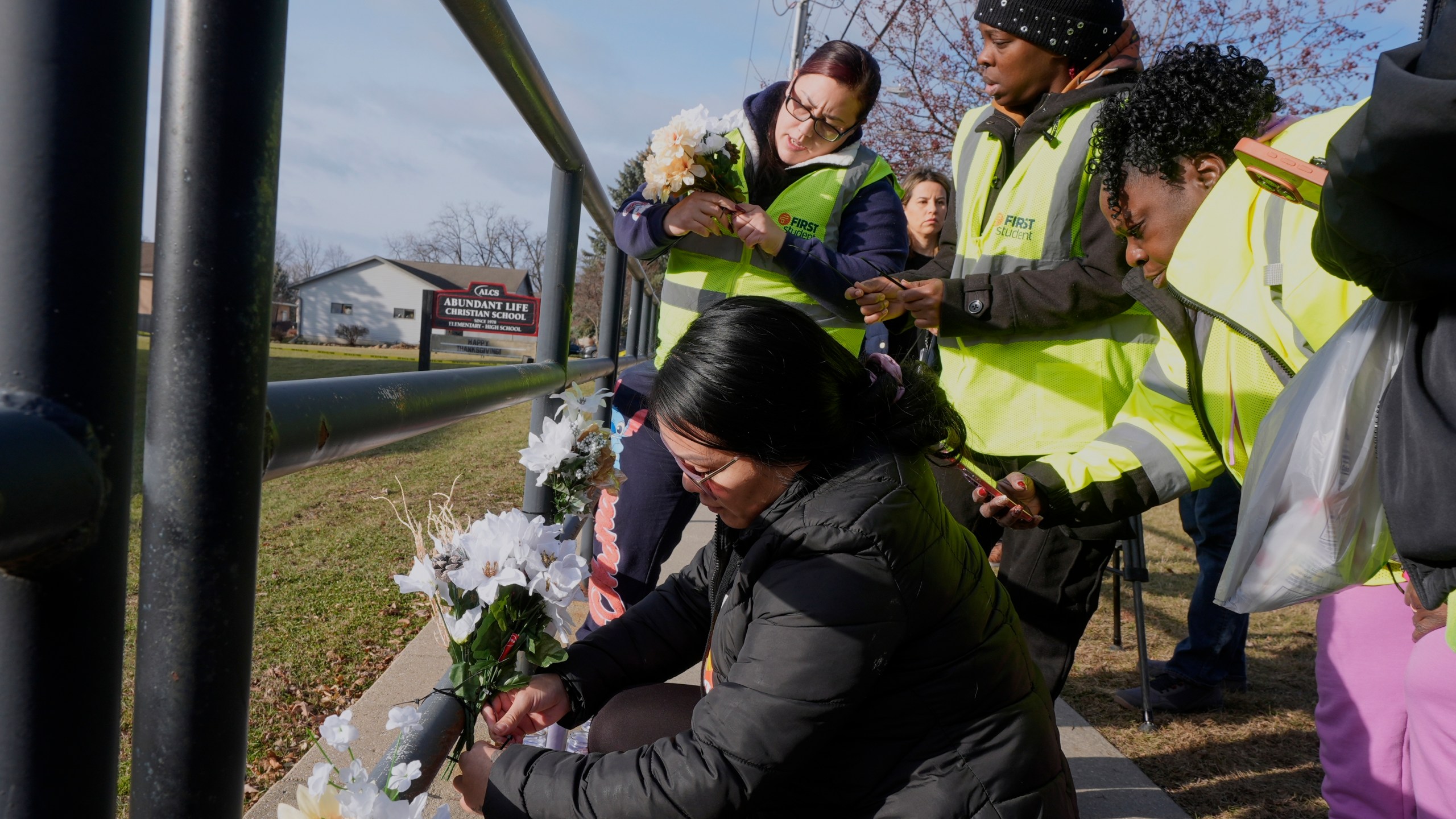 People put flowers outside the Abundant Life Christian School Tuesday, Dec. 17, 2024 in Madison, Wis., following a shooting on Monday. (AP Photo/Morry Gash)