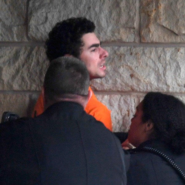 Luigi Nicholas Mangione is escorted into Blair County Courthouse, Tuesday, Dec. 10, 2024, in Hollidaysburg, Pa. (AP Photo/Gary M. Baranec)