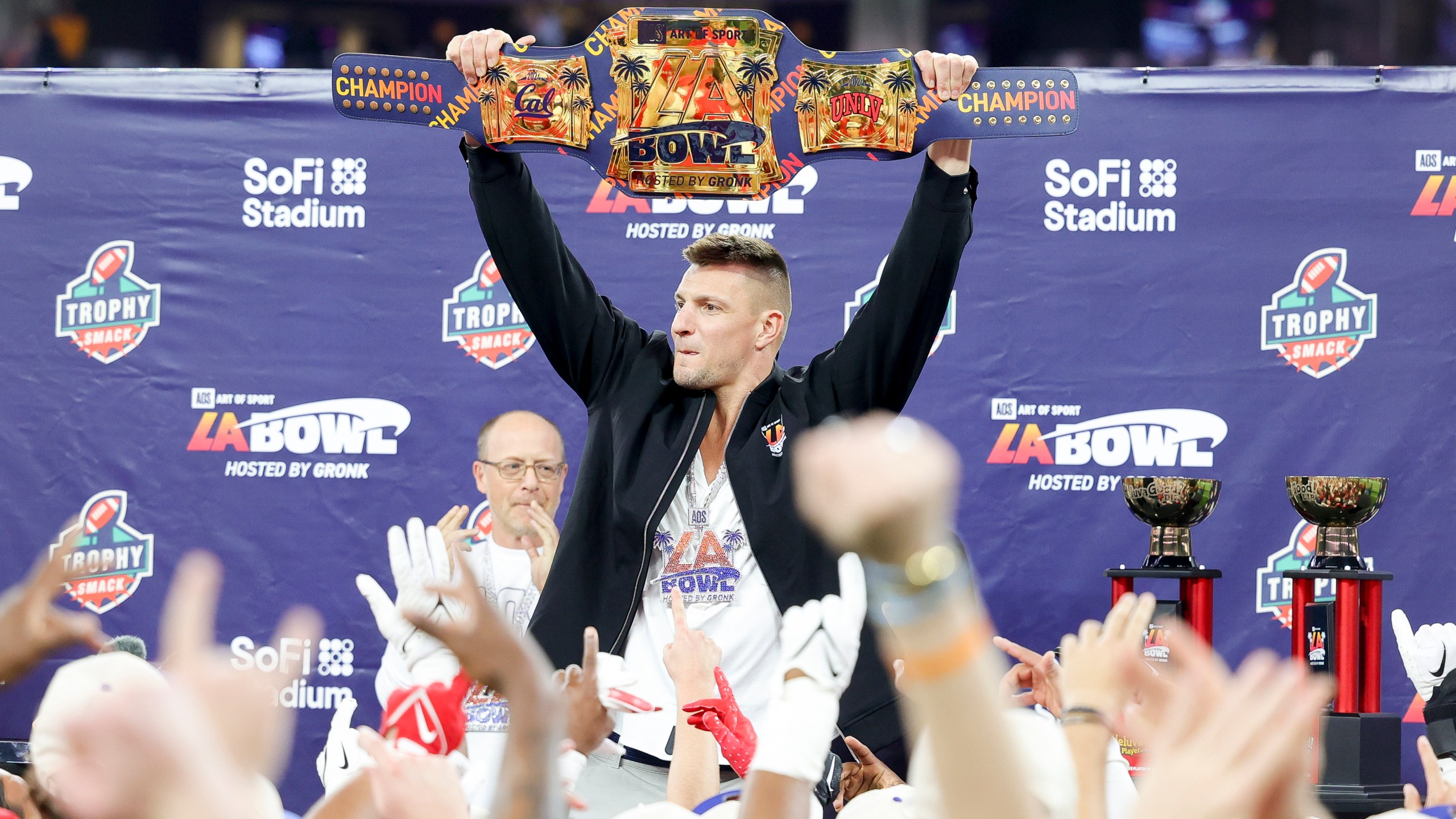 Former NFL tight end Rob Gronkowski holds up the LA Bowl belt after UNLV's victory over California during the LA Bowl NCAA college football game Wednesday, Dec. 18, 2024, in Inglewood, Calif. (AP Photo/Ryan Sun)