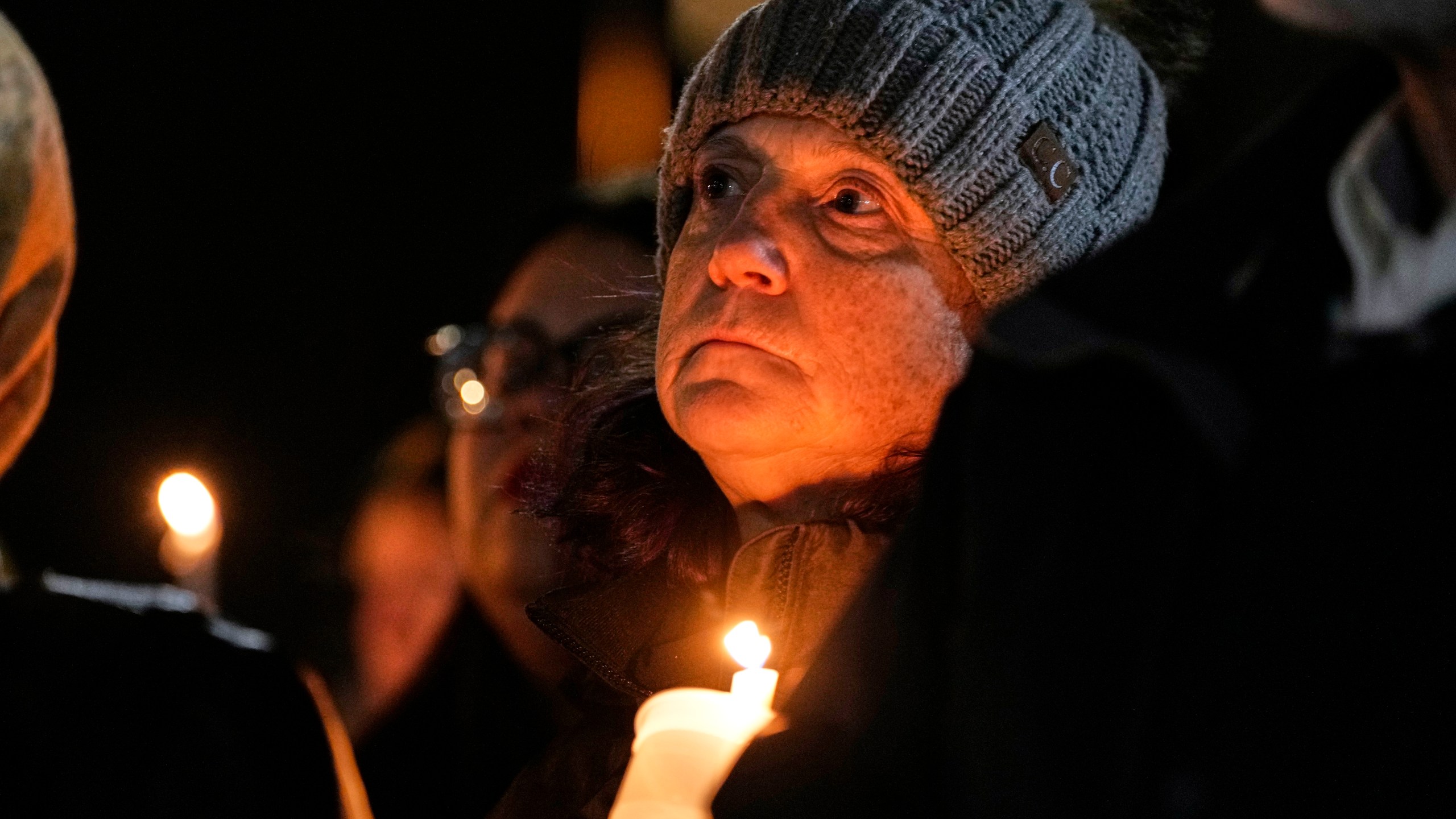 Supporters hold candles during a candlelight vigil Tuesday, Dec. 17, 2024, outside the Wisconsin Capitol in Madison, Wis., following a shooting at the Abundant Life Christian School on Monday, Dec. 16. (AP Photo/Morry Gash)