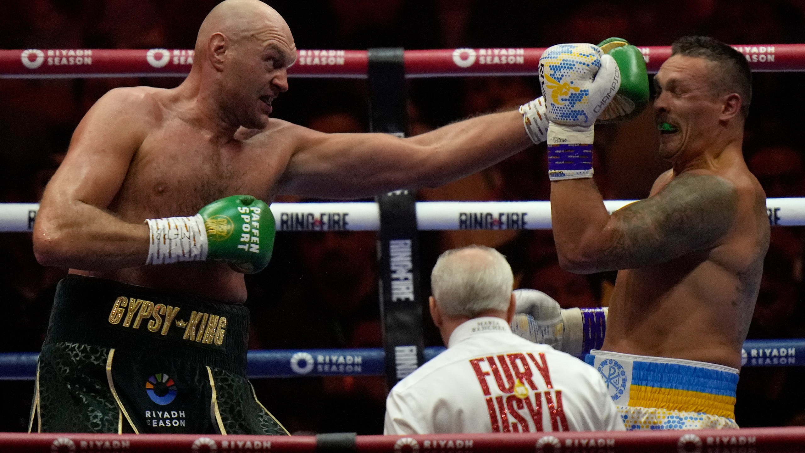 FILE - Britain's Tyson Fury, left, punches Ukraine's Oleksandr Usyk during their undisputed heavyweight world championship boxing fight at the Kingdom Arena in Riyadh, Saudi Arabia, May 19, 2024. (AP Photo/Francisco Seco, File)