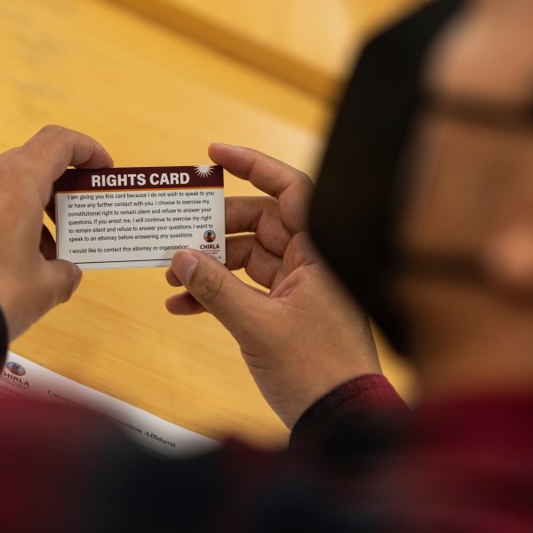 A participant holds a "rights card" during a bilingual workshop for immigrants who want to stay in the United States at the office of the Coalition for Humane Immigrant Rights organization in Los Angeles, Wednesday, Dec. 4, 2024. (AP Photo/Jae C. Hong)