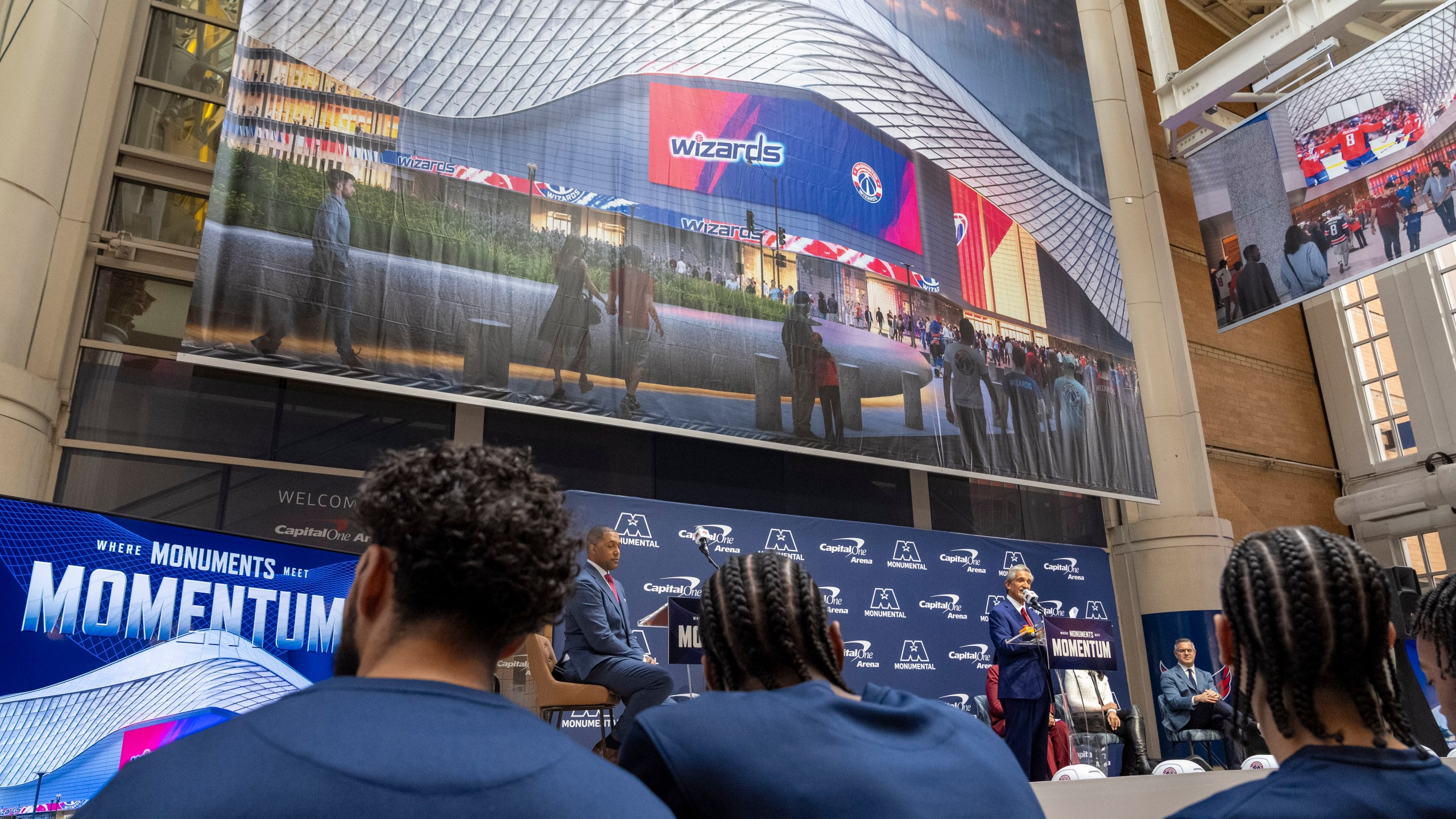 Members of the Washington Wizards NBA Basketball team listen as Ted Leonsis, owner of the Washington Wizards NBA basketball team and Washington Capitals NHL hockey team, speaks during an event announcing the start of work on a new Capital One Arena Gallery Place Atrium, Thursday, Dec. 19, 2024, in Washington. (AP Photo/Jacquelyn Martin)